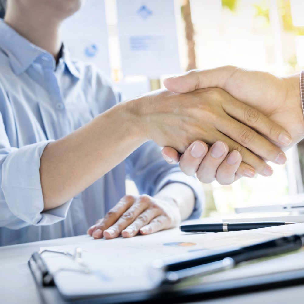 Businessmen shaking hands during a meeting.